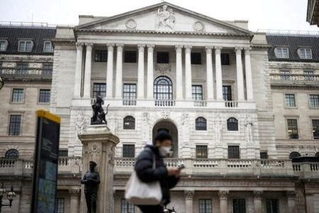 A file photo of a person walking past the Bank of England in the City of London financial district in London, Britain, January 23, 2022. 