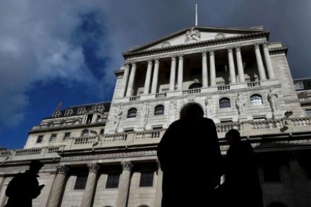 A file photo shows city workers walk past the Bank of England in the City of London, Britain, March 29, 2016. 