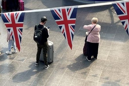 A file photo of passengers standing by their luggage ahead of a planned national strike by rail workers at Manchester Piccadilly Station in Manchester, Britain, June 20, 2022. A file photo of passengers standing by their luggage ahead of a planned national strike by rail workers at Manchester Piccadilly Station in Manchester, Britain, June 20, 2022.