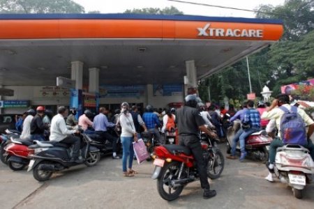 A file photo shows people lining up for their turn to fill fuel at a petrol pump in Lucknow, India, November 9, 2016.