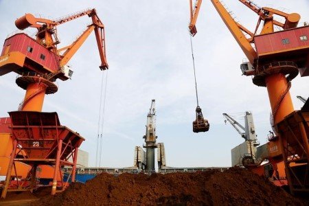 A file photo of cranes unloading imported iron ore from a cargo vessel at a port in Lianyungang, Jiangsu province, China October 27, 2019.