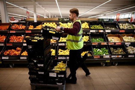 A file photo shows an employee arranging produce inside a Sainsbury’s supermarket in Richmond, west London, Britain, June 27, 2022. 