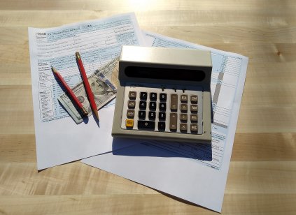 Tax filing concept with Form 1040, pencils and calculator