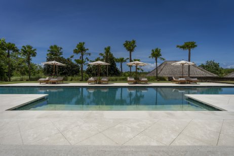 Empty pool lounge chairs at Revivo Wellness Resort, Bali
