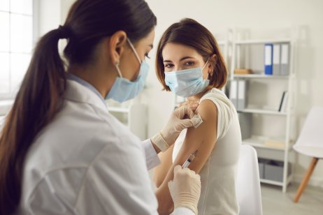 A woman in getting vaccinated at a medical centre
