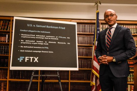 US attorney Damian Williams in front of board listing allegations against Sam Bankman-Fried