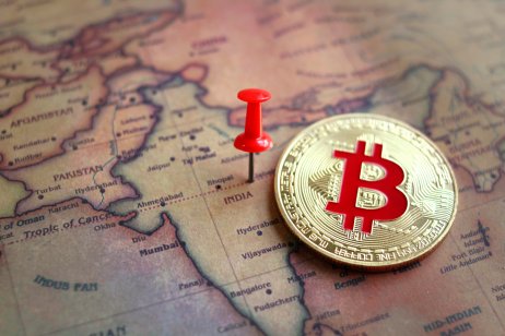 Bitcoin token lying on top of a map of India