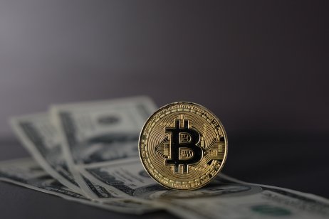 Bitcoin on a background of US bills