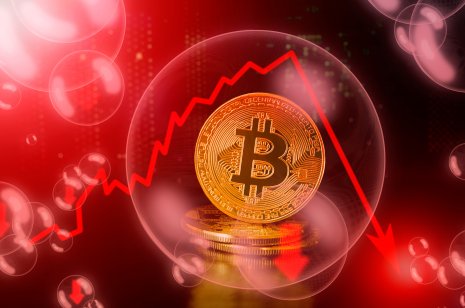 Bitcoin sign on bubble with down red arrow