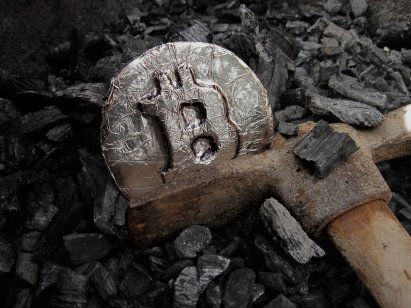 A Bitcoin symbol lodged in a mining shot
