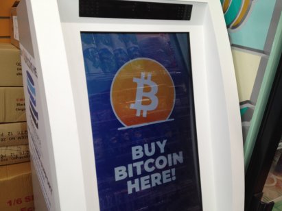 An ATM with a screen displaying the words 'Buy Bitcoin here'