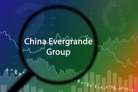 China Evergrande Group seen through a magnifying glass layered with graphs and charts