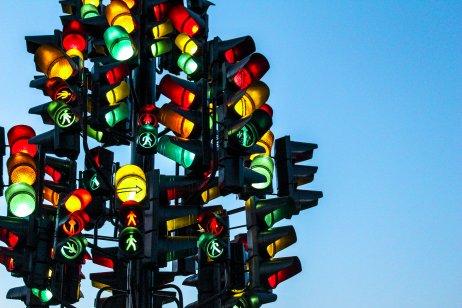 A concept of red, amber and green traffic lights glowing in unison.
