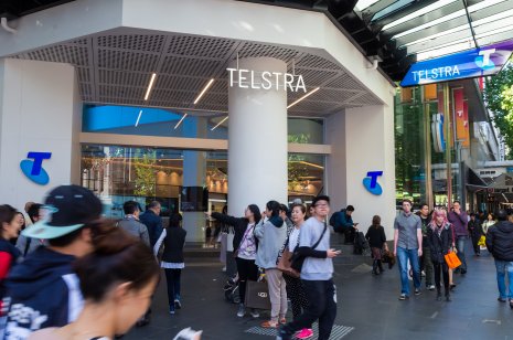 Crowd passing Telstra shop in Melbourne, Australia
