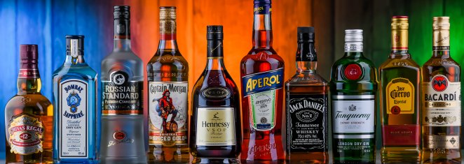 Bottles of assorted global hard liquor brands including whiskey, vodka, tequila and gin