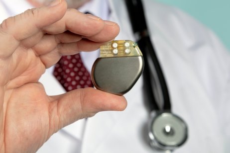 A doctor holding pacemaker device