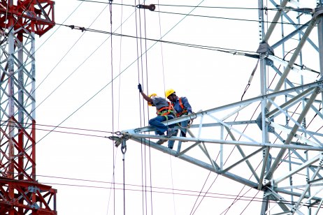 Workers testing a transmission tower, India