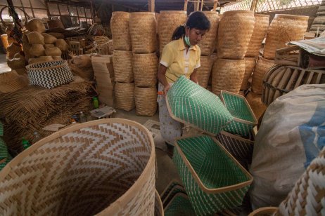 Female worker arranging bamboo handicrafts produced by Indonesian small businesses