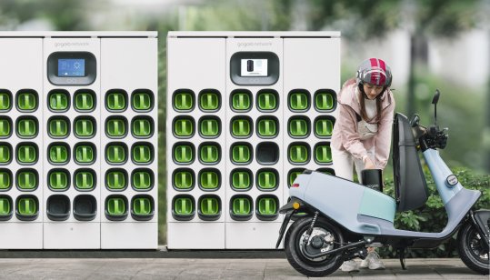 Person swapping Gogoro electric scooter batteries