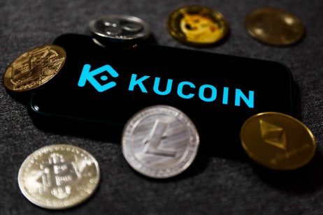Smartphone displays KuCoin name and logo surrounded by cryptos