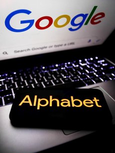 Alphabet logo displayed on a phone screen and Google logo displayed on a laptop screen are seen in this illustration photo taken in Krakow, Poland on October 30, 2021
