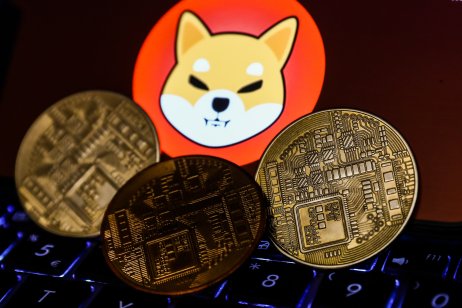 Shiba Inu cryptocurrency logo displayed on a phone screen and representation of cryptocurrency are seen in this illustration photo taken in Krakow, Poland on 2 November 2021