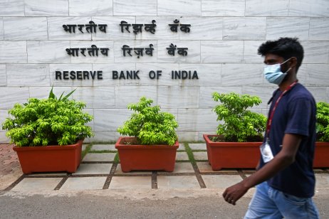 A pedestrian walks past the entrance of the Reserve Bank of India (RBI) headquarters in Mumbai