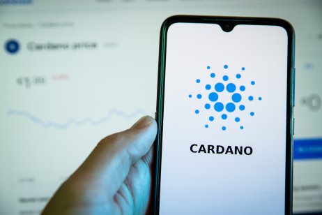 The Cardano logo and name are displayed on a smartphone
