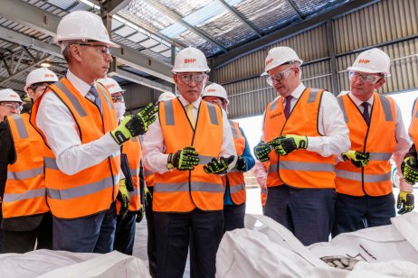 BHP CEO Mike Henry (far left) discussing plans with government officials