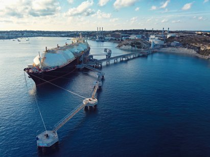 Stock photo of a Liquefied Natural Gas (LNG) tanker moored to a jetty