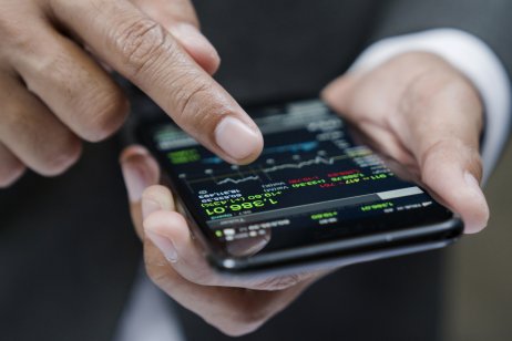 businessman using a mobile phone to check stock market data