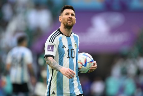 Lionel Messi of Argentina holds a football during the World Cup group C match between Argentina and Saudi Arabia