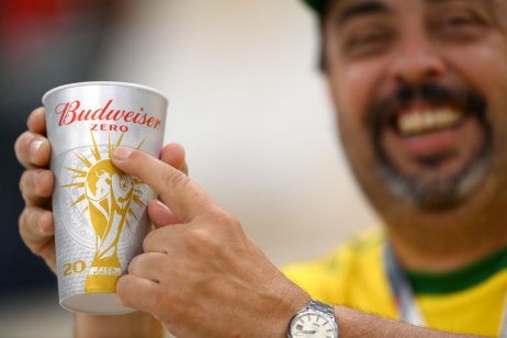 A image of a football fan holding a Budweiser zero cup 