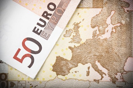 Two €50 banknotes on a map of Europe