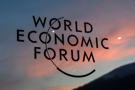 A sunset is reflected in the World Economic Forum’s plaque at Davos