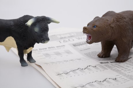 bull vs bear on top of a stock market newspaper 
