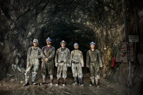 Coal miners standing in front of a coal shaft 