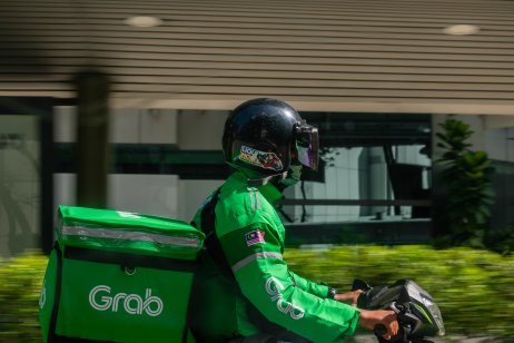 A Grab driver in Malaysia delivering food on a two-wheeler