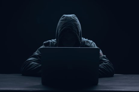 A hacker in a hoodie with a digital imprint