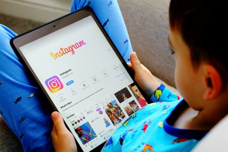 A child looks at Instagram on an iPad