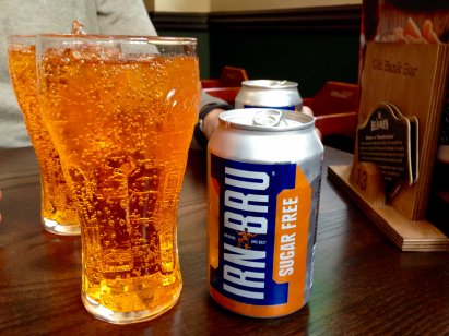 Glasses of Irn Bru next to a can