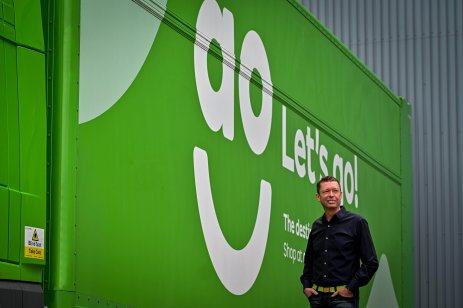 AO World's CEO John Roberts in front of a hoarding with the company’s logo