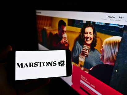 Advertisement for Marston's pub showing people drinking socially indoors and the logo