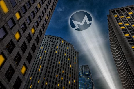  Monero cryptocurrency logo light beam projecting on a dark sky between skyscrapers