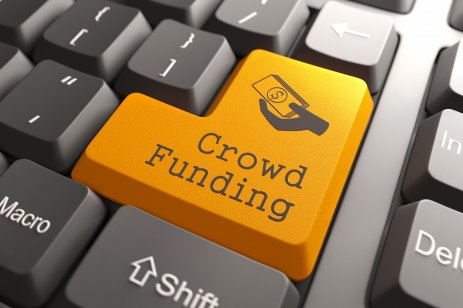 A laptop keyboard with the word crowdfunding