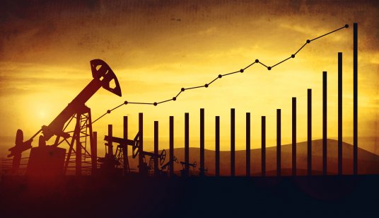 Image of financial chart against backdrop of an oil field