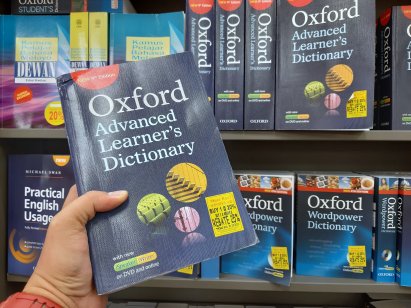 Someone holding an Oxford Dictionary 