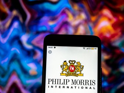 Philip Morris logo on a smartphone set against a colourful background
