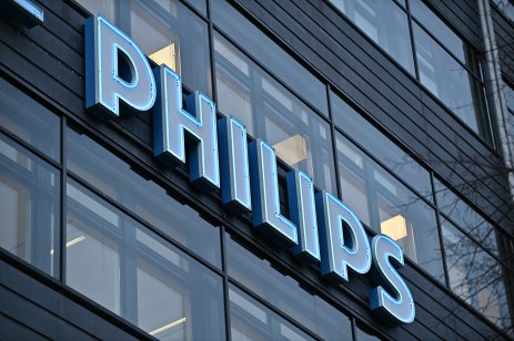 A blue neon company sign for Philips glows on an office building in Stockholm, Sweden
