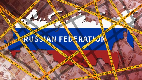 Yellow ribbons with the inscription 'sanctions' wrapped around the map of the Russian Federation, painted in the colours of the flag. Economic isolation of Russia concept. Banknotes 5000 rubles